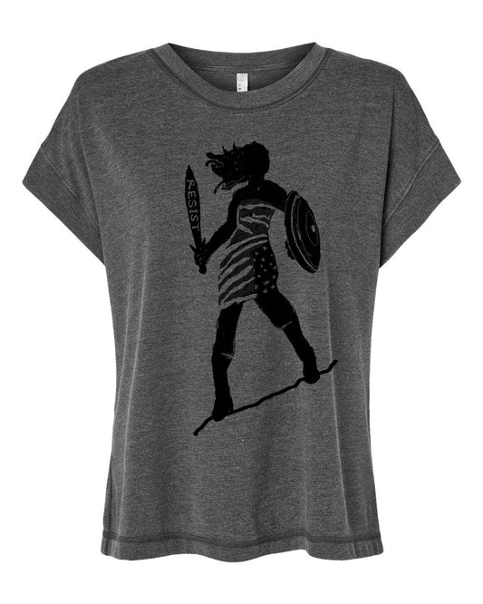 A gray t-shirt with a black graphic design depicting a woman holding a shield and sword, with the word "RESIST" written on the shield.