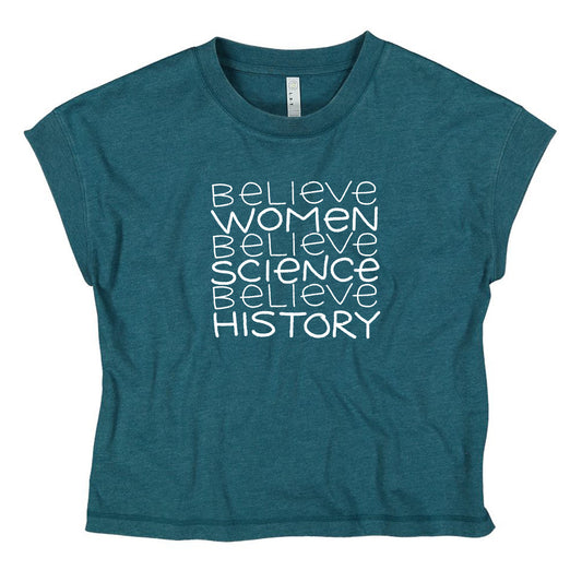 A teal-colored t-shirt with the text "Believe Women Believe Science Believe History" printed on it in a white font.