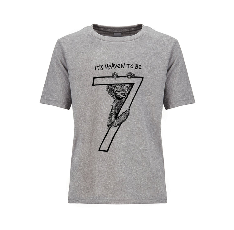 A gray t-shirt with a graphic design depicting a sloth hanging from a tree branch with the text "It's Heaven to Be" above it.