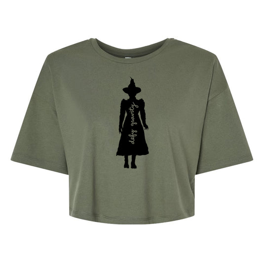 A green t-shirt with a silhouette of a person wearing a hat and a long dress printed on it.
