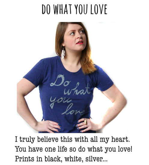 A woman wearing a blue t-shirt with the text "Do what you love" is standing with her hands on her hips, looking off to the side.
