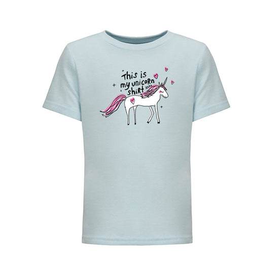A light blue t-shirt with a cartoon illustration of a white unicorn and the text "This is my unicorn shirt" printed on it.