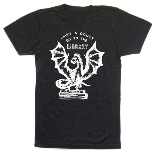 A black t-shirt with a white graphic design depicting a dragon and the text "WHEN IN DOUBT GO TO THE LIBRARY" printed on it.