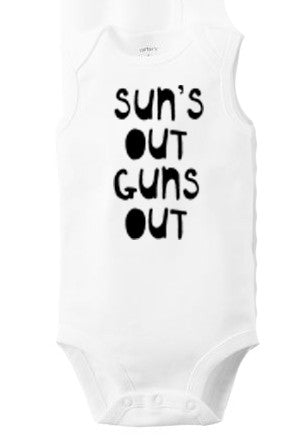 A white baby onesie with the text "SUN'S OUT GUNS OUT" printed on it.
