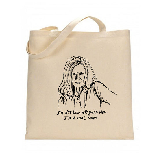 A beige tote bag with a black and white illustration of a woman's face and the text "I'm not like a regular mom. I'm a cool mom."