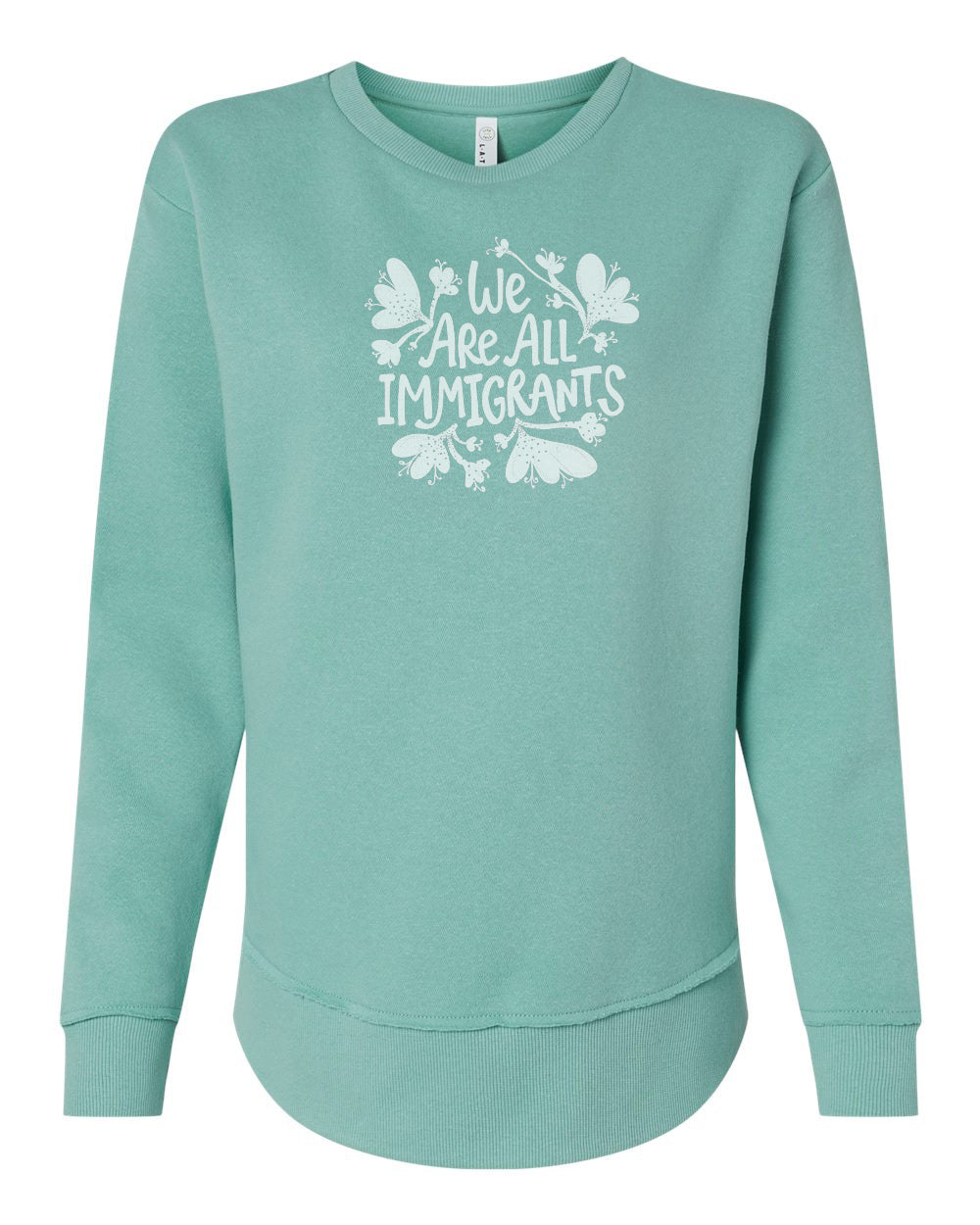 A mint green sweatshirt with a white graphic design on the front that reads "We Are All Immigrants".