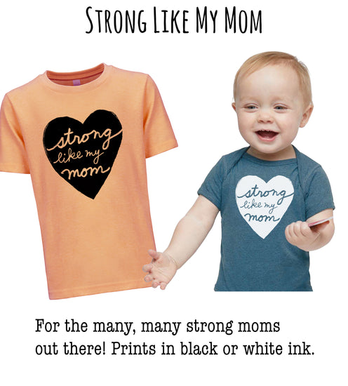 A smiling baby wearing a blue shirt with a heart design and a matching orange t-shirt with a heart design, both featuring the phrase "Strong Like My Mom".