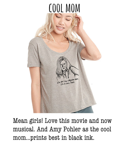 A woman wearing a gray t-shirt with a graphic of a woman's face and text that says "I'm like a regular mom. I'm a cool mom."