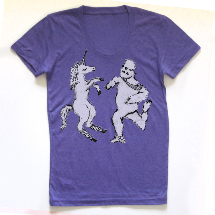 A purple t-shirt with a graphic design depicting a unicorn and a creature resembling a bear or similar animal.
