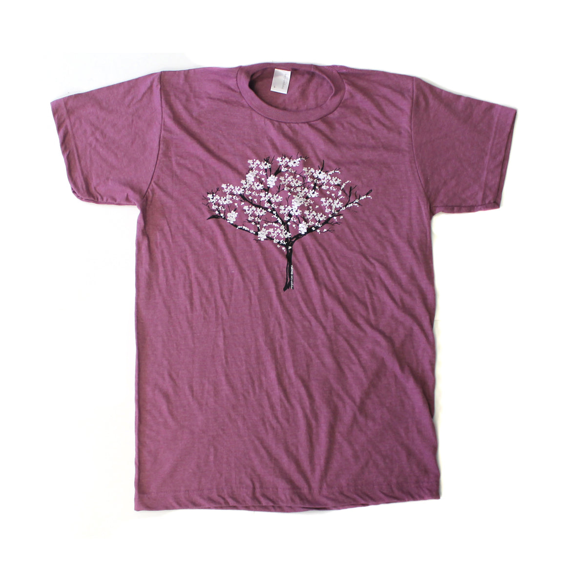 A purple t-shirt with a graphic design of a tree with pink flowers printed on it.