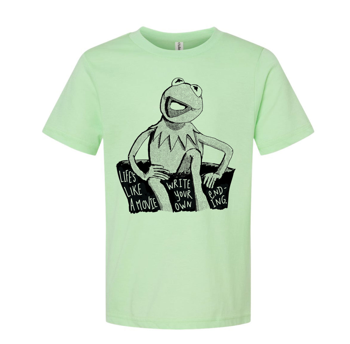 A light green t-shirt with a black and white illustration of Kermit the Frog sitting on a rock and the text "Lives like a movie, write your own ending" printed on it.