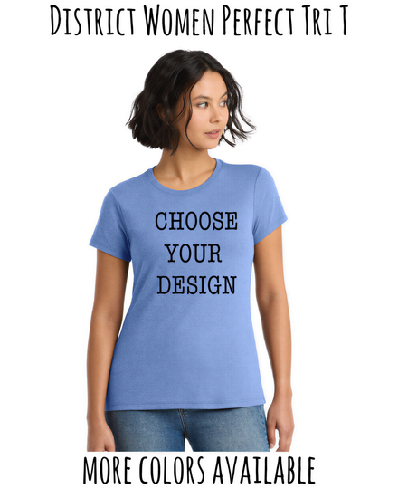 A woman wearing a blue t-shirt with the text "CHOOSE YOUR DESIGN" printed on it, standing against a white background.