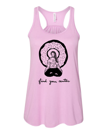 A pink tank top with a graphic design of a woman sitting in a meditative pose, surrounded by a circular pattern resembling a donut. The text below the graphic says "find your center".
