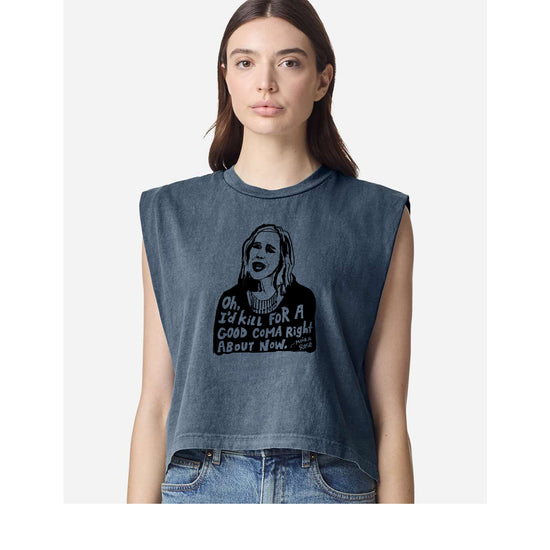 A woman wearing a gray sleeveless top with a graphic design and text printed on it.