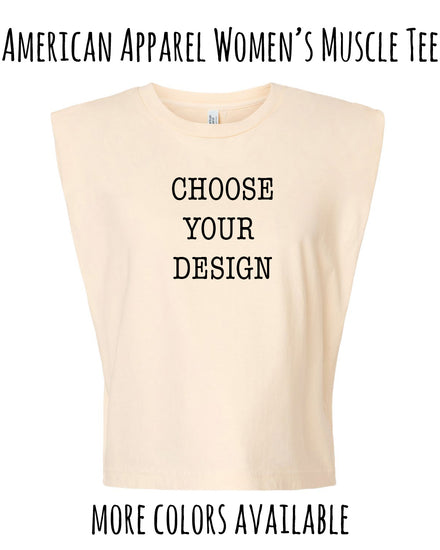 The image is an advertisement for a women's muscle t-shirt. It features a beige t-shirt with the text "CHOOSE YOUR DESIGN" printed on it, along with the text "AMERICAN APPAREL WOMEN'S MUSCLE T-SHIRT" at the top. The image also includes the text "MORE COLORS AVAILABLE" at the bottom.