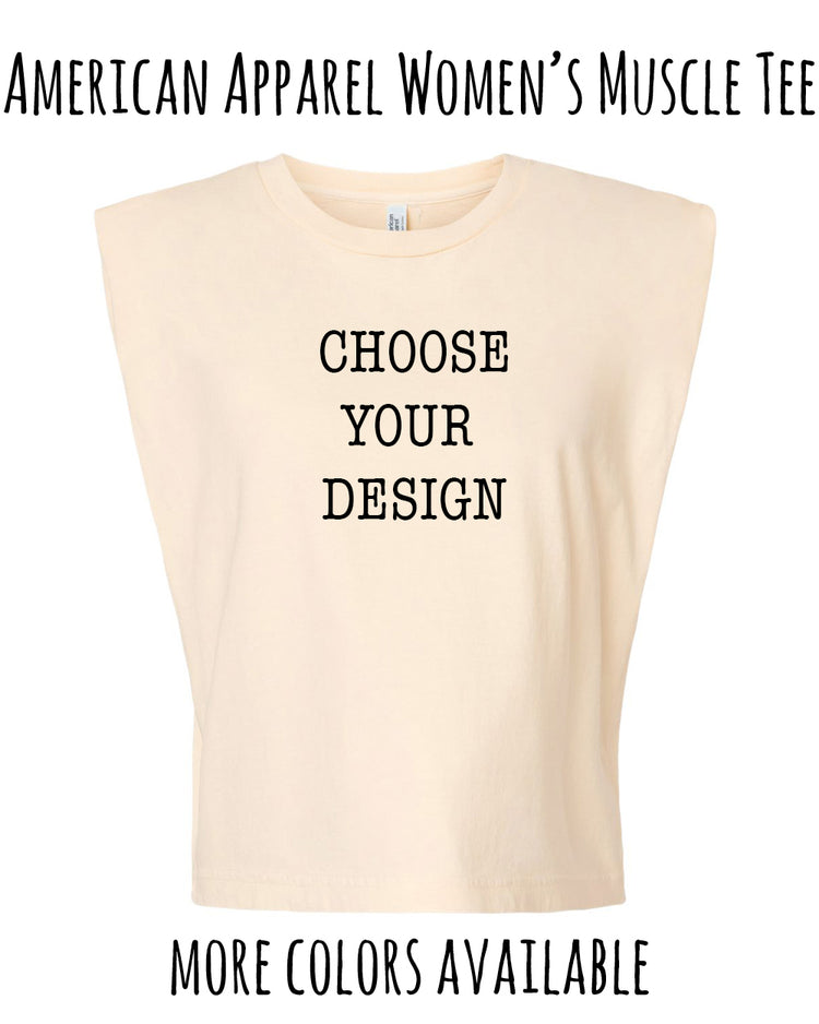 The image is an advertisement for a women's muscle t-shirt. It features a beige t-shirt with the text "CHOOSE YOUR DESIGN" printed on it, along with the text "AMERICAN APPAREL WOMEN'S MUSCLE T-SHIRT" at the top. The image also includes the text "MORE COLORS AVAILABLE" at the bottom.