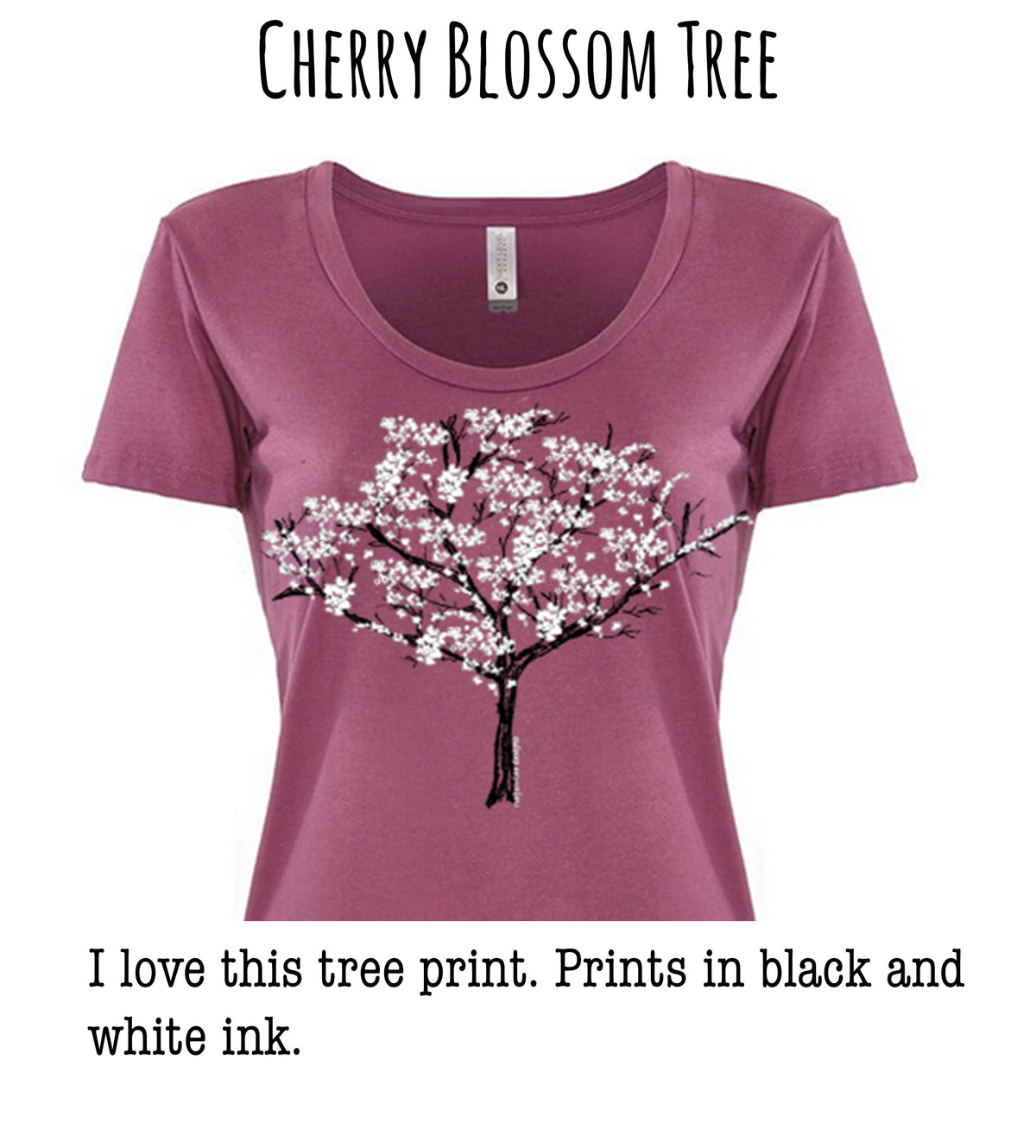 A pink t-shirt with a cherry blossom tree design printed on it.