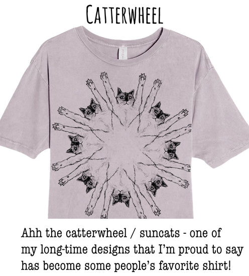 A gray t-shirt with a circular design featuring a group of cats with their paws raised in a sunburst pattern.
