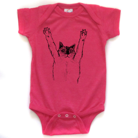 A pink baby onesie with a black cat graphic printed on it.