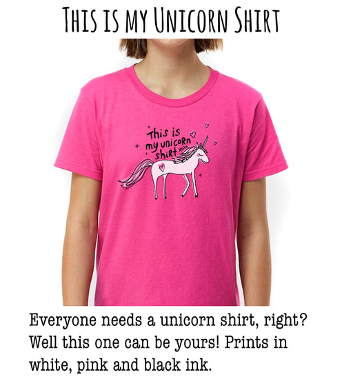 This is a pink t-shirt with a unicorn graphic and text that says "This is my unicorn shirt" and "This is my unicorn shirt" repeated.