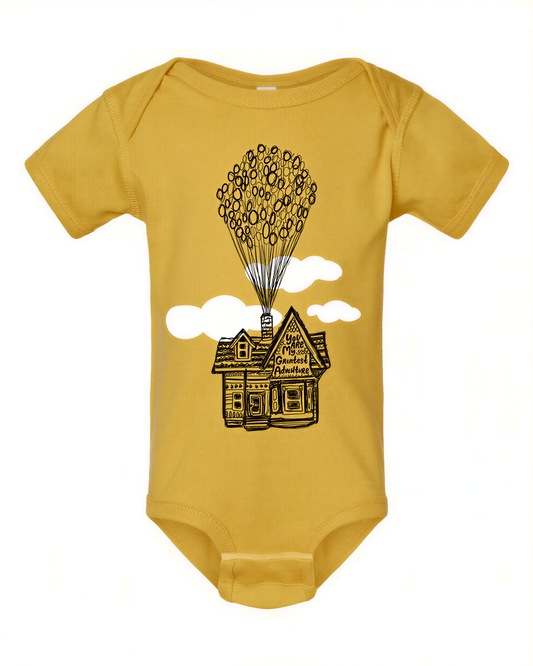 A yellow baby onesie with a graphic of a house and balloons floating above it.
