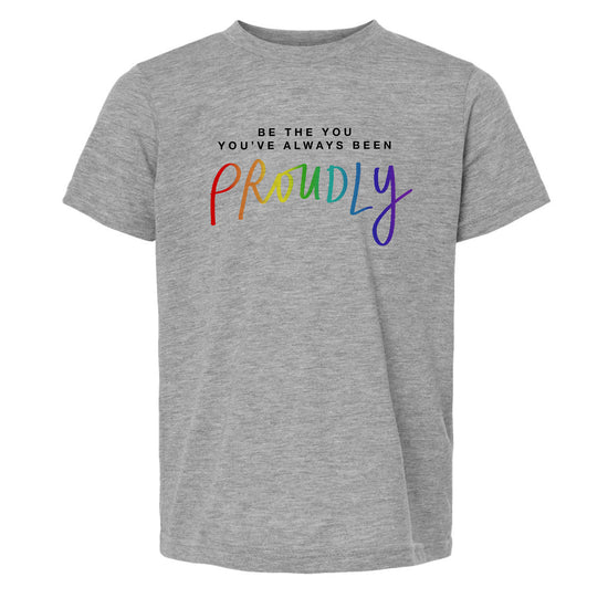 A gray t-shirt with the text "Be the you've always been Proudly" printed on it.