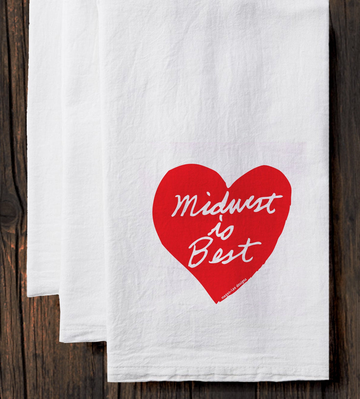 A white towel with a red heart-shaped graphic and the text "Midwest to Best" printed on it.