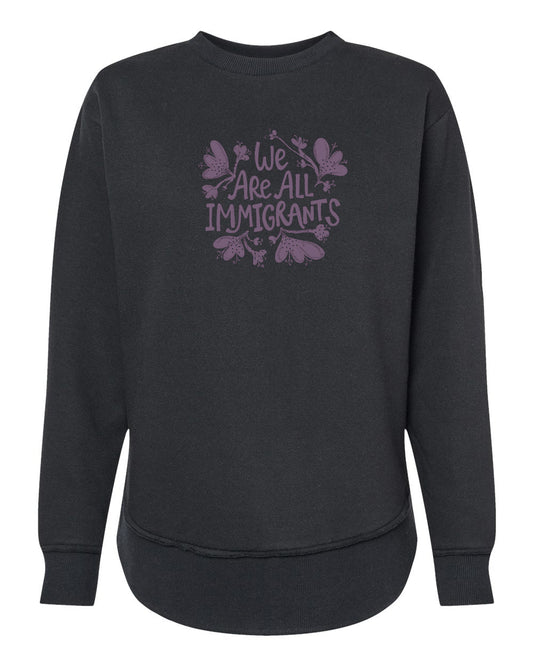 A black sweatshirt with a purple graphic design on the front that reads "We Are All Immigrants".