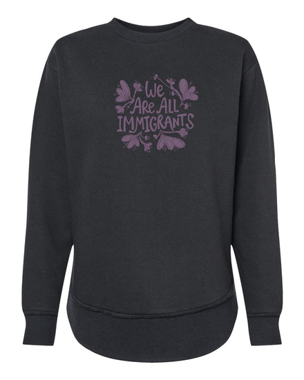 A black sweatshirt with a purple graphic design on the front that reads "We Are All Immigrants".
