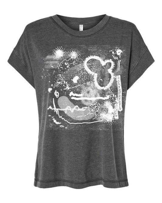 The image is a gray t-shirt with a white abstract design featuring various shapes and patterns.