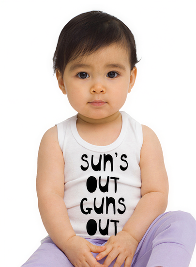 A young child wearing a white tank top with the text "SUN'S OUT GUNS OUT" printed on it.
