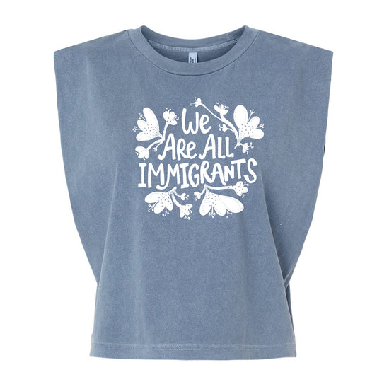 A gray t-shirt with a white graphic design that reads "We Are All Immigrants".