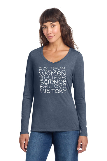 A woman wearing a gray long-sleeved shirt with white text printed on it.