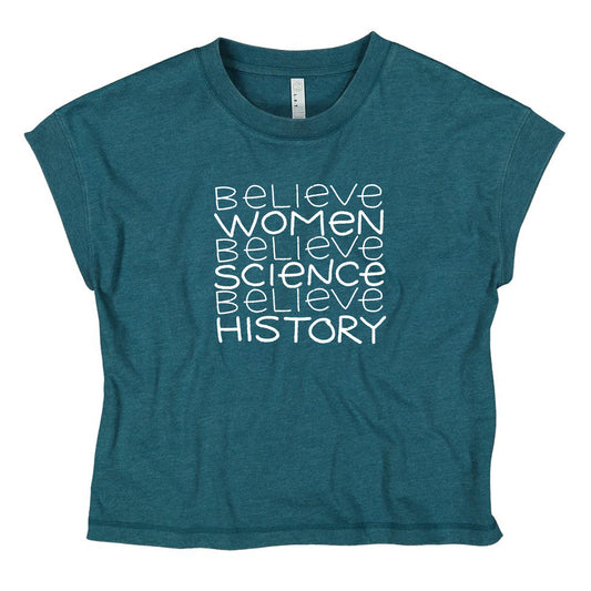 A teal-colored t-shirt with the text "Believe Women Believe Science Believe History" printed on it in a white font.