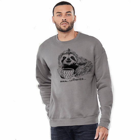 A man wearing a gray sweatshirt with a black and white illustration of a sloth holding a cup of coffee.