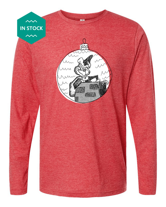 a red long - sleeved shirt with a picture of a man on a boat