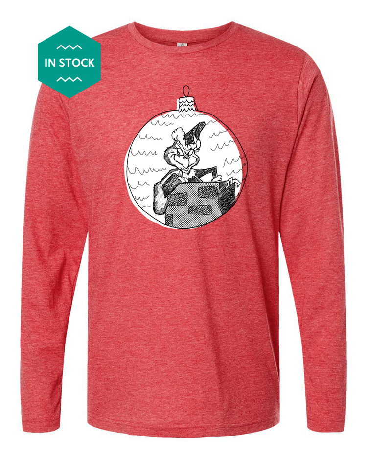 a red long - sleeved shirt with a picture of a man on a boat