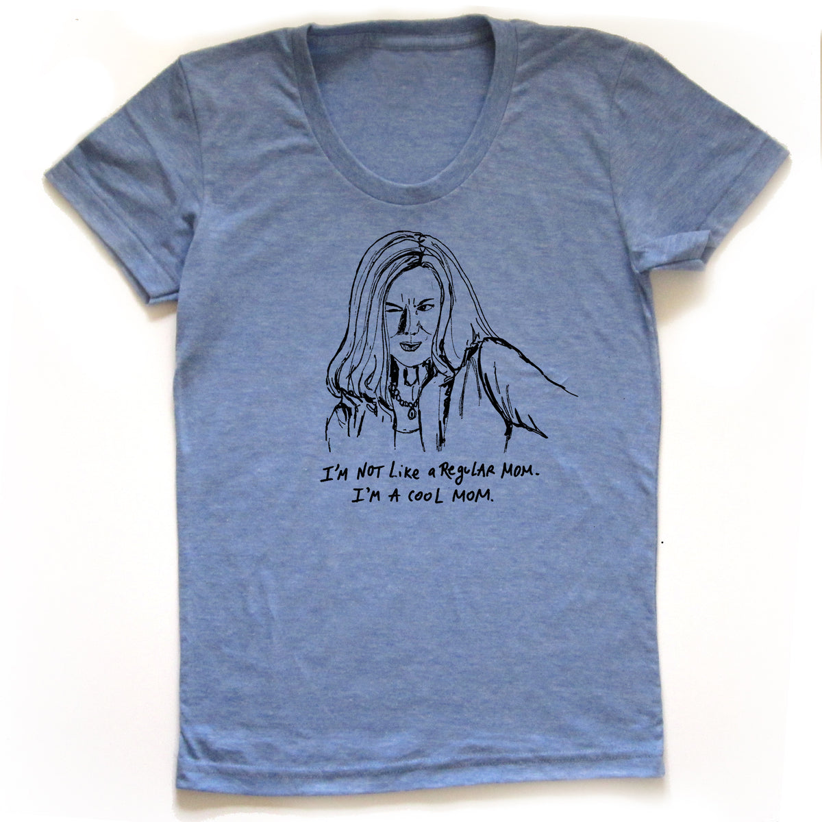 A blue t-shirt with a black and white illustration of a woman's face and the text "I'M NOT LIKE A REGULAR MOM. I'M A COOL MOM."