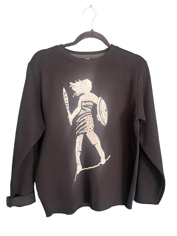 A black long-sleeved shirt with a white graphic design depicting a person holding a shield and a sword.