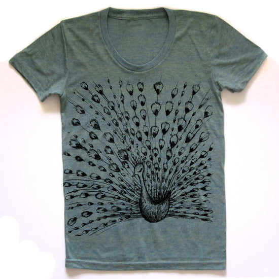 A gray t-shirt with a black and white illustration of a peacock displaying its vibrant, colorful feathers.