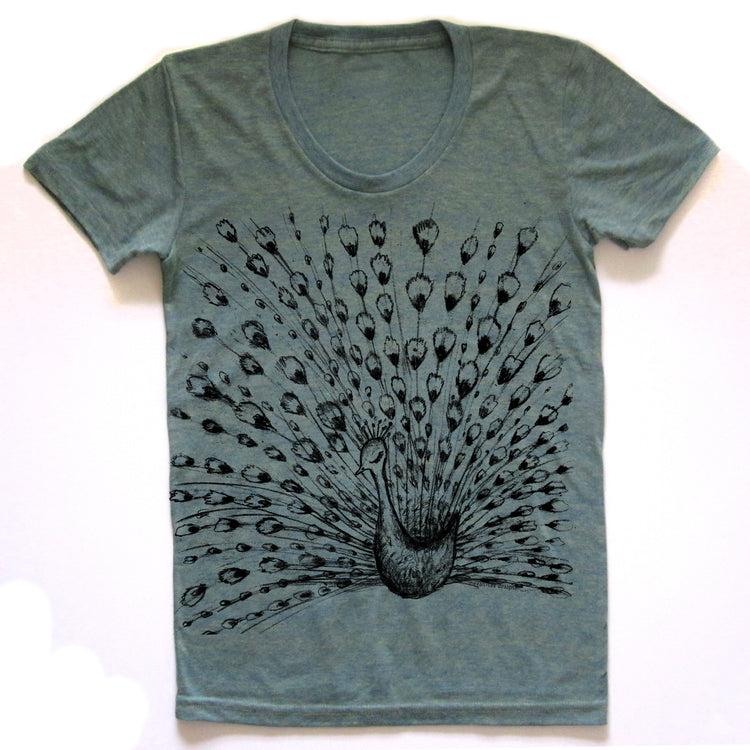 A gray t-shirt with a black and white illustration of a peacock displaying its vibrant, colorful feathers.