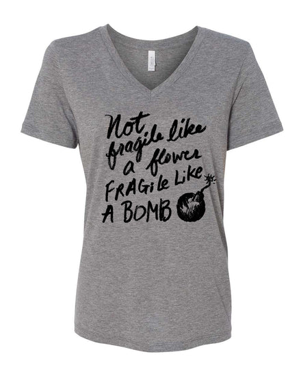 A gray t-shirt with a black text design that reads "Not fragile like a flower, fragile like a bomb".