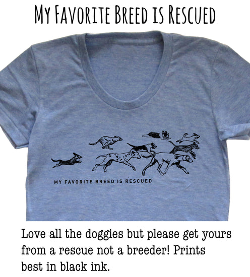 A gray t-shirt with a graphic design depicting a group of dogs running together, accompanied by the text "My favorite breed is rescued" and a message encouraging people to adopt rescue dogs instead of buying from breeders.