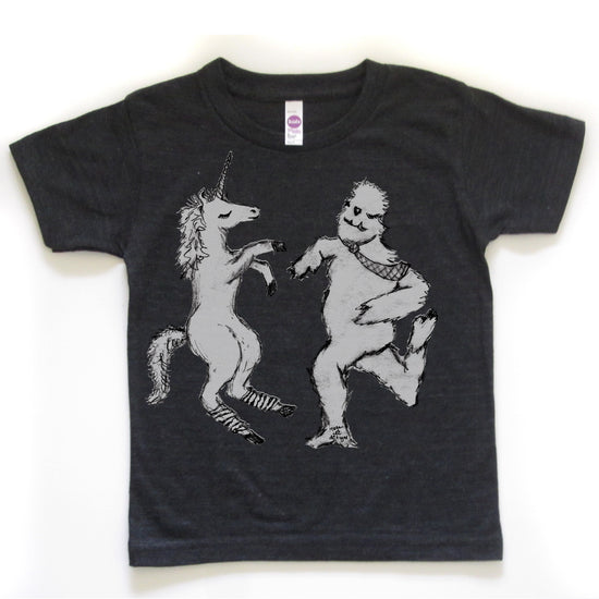 A black t-shirt with a graphic design depicting a unicorn and a creature, possibly a dragon or monster, dancing together.