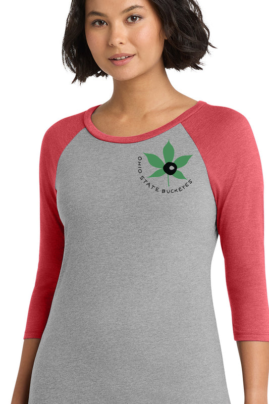 A woman wearing a gray and red shirt with a graphic of a leaf and the text "Ohio State Buckeye" printed on it.