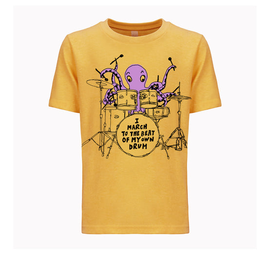 A yellow t-shirt with a graphic design depicting an octopus playing a drum set, accompanied by the text "I MARCH TO THE BEAT OF MY OWN DRUM".
