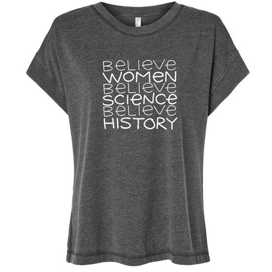 A gray t-shirt with the text "Believe Women Believe Science Believe History" printed on it in white lettering.
