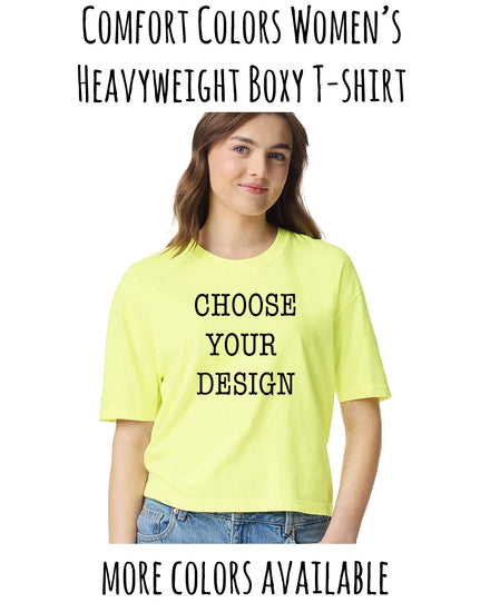 A woman wearing a yellow t-shirt with the text "CHOOSE YOUR DESIGN" printed on it, smiling at the camera.