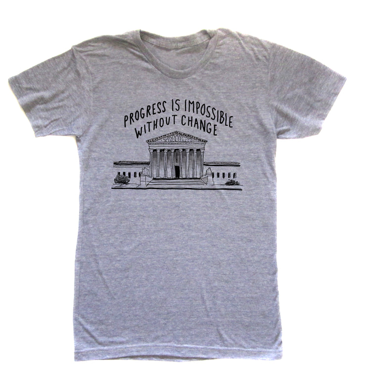 A gray t-shirt with a graphic design depicting a building and the text "Progress is impossible without change" printed on it.