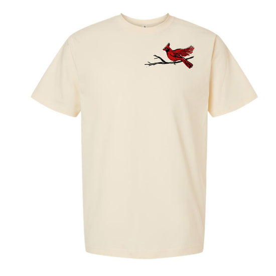 A cream-colored t-shirt with a red cardinal bird perched on a branch on the left side of the chest area.